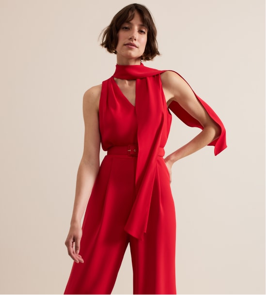 Woman wearing Phase Eight red jumpsuit