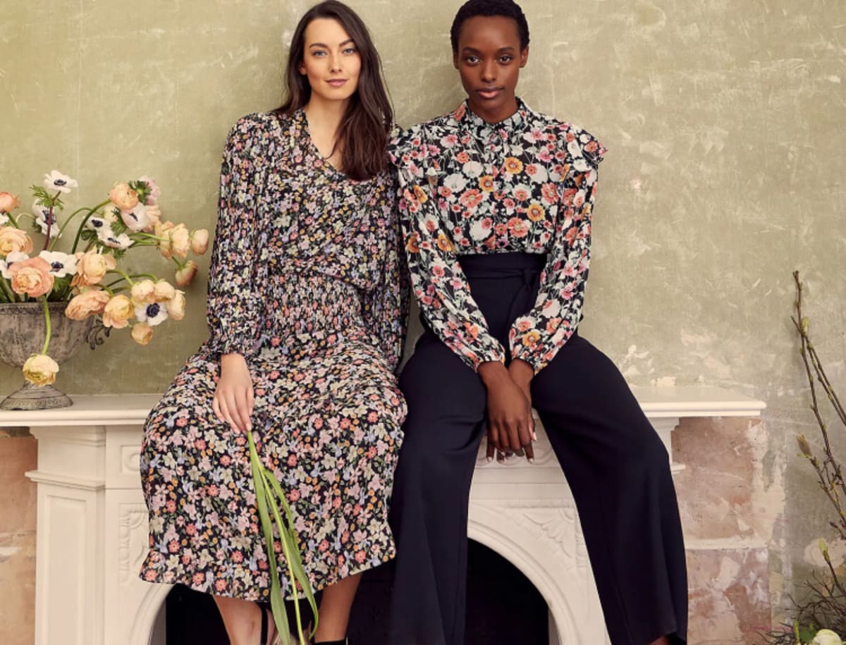 Woman wearing floral dress, woman wearing floral shirt and black trousers