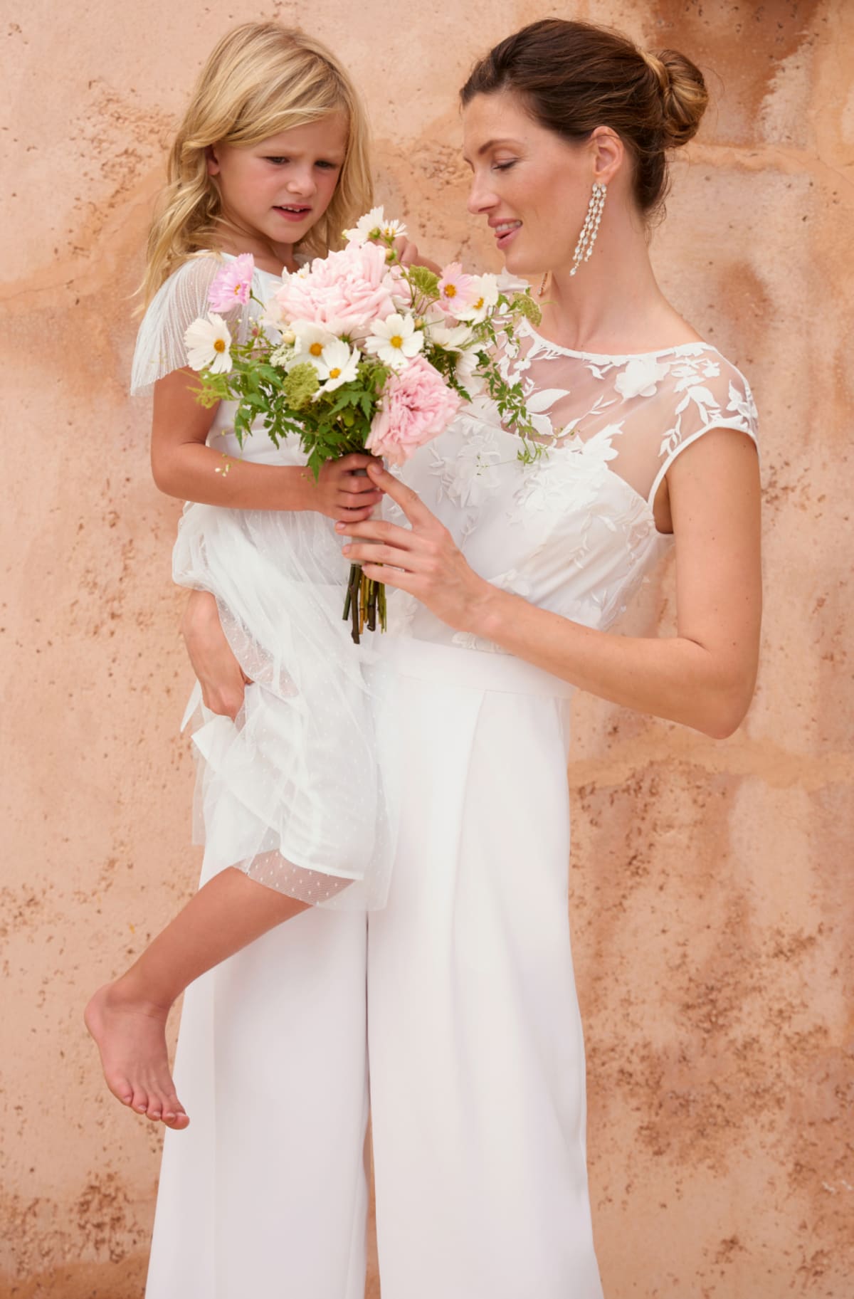 Child wearing Phase Eight Childrenswear Flower Girl Dress with woman wearing Phase Eight Poppy Wedding Dress