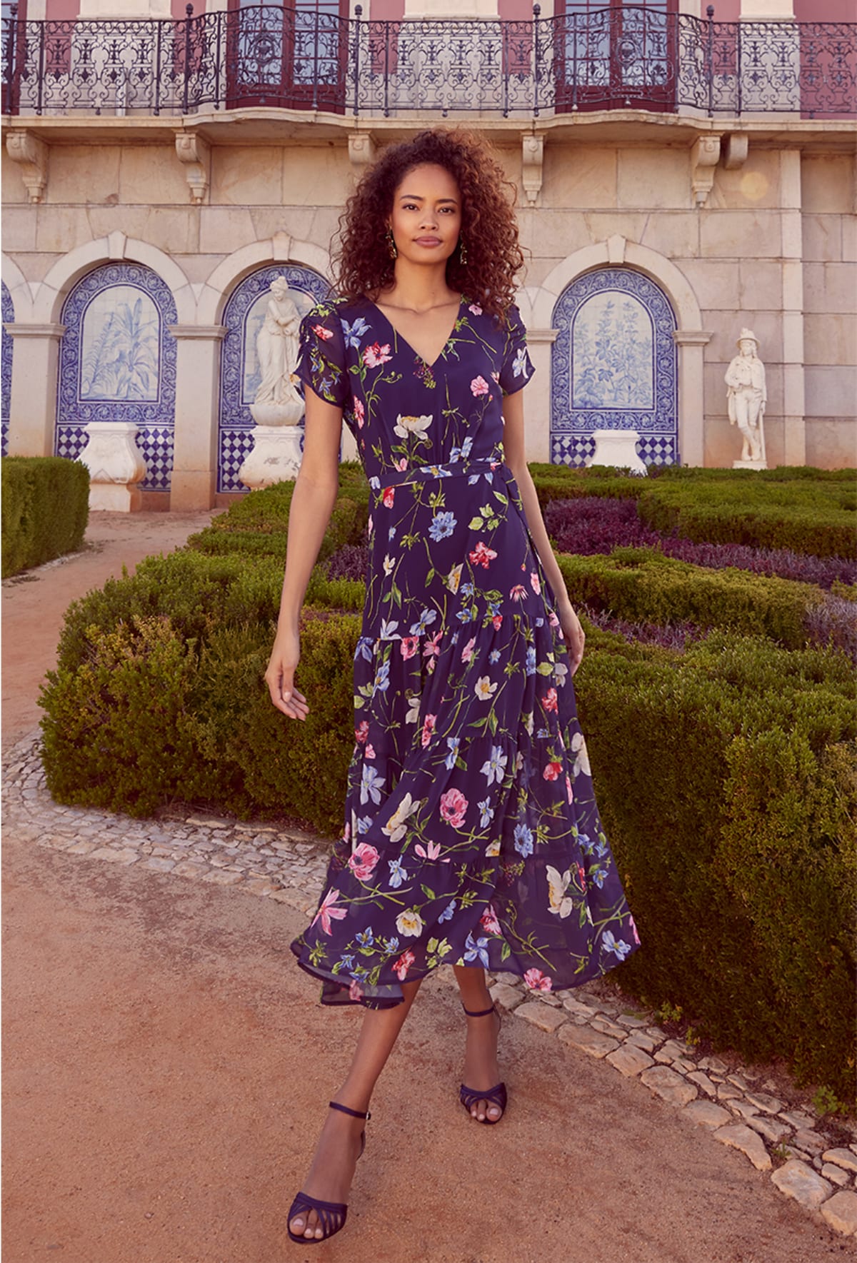 Woman wearing Phase Eight Lola floral tiered midi dress