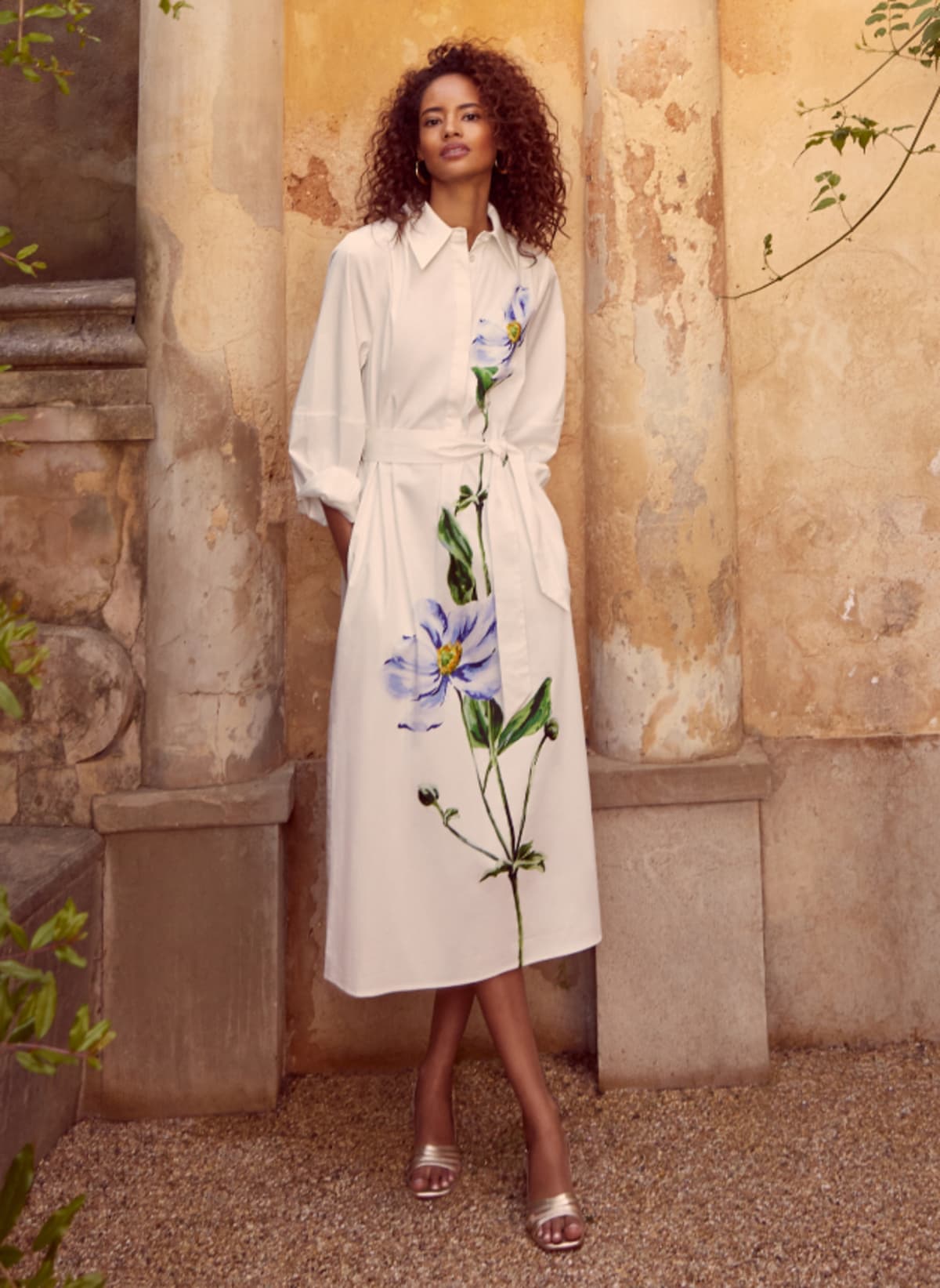 Woman wearing white shirt dress with floral placement