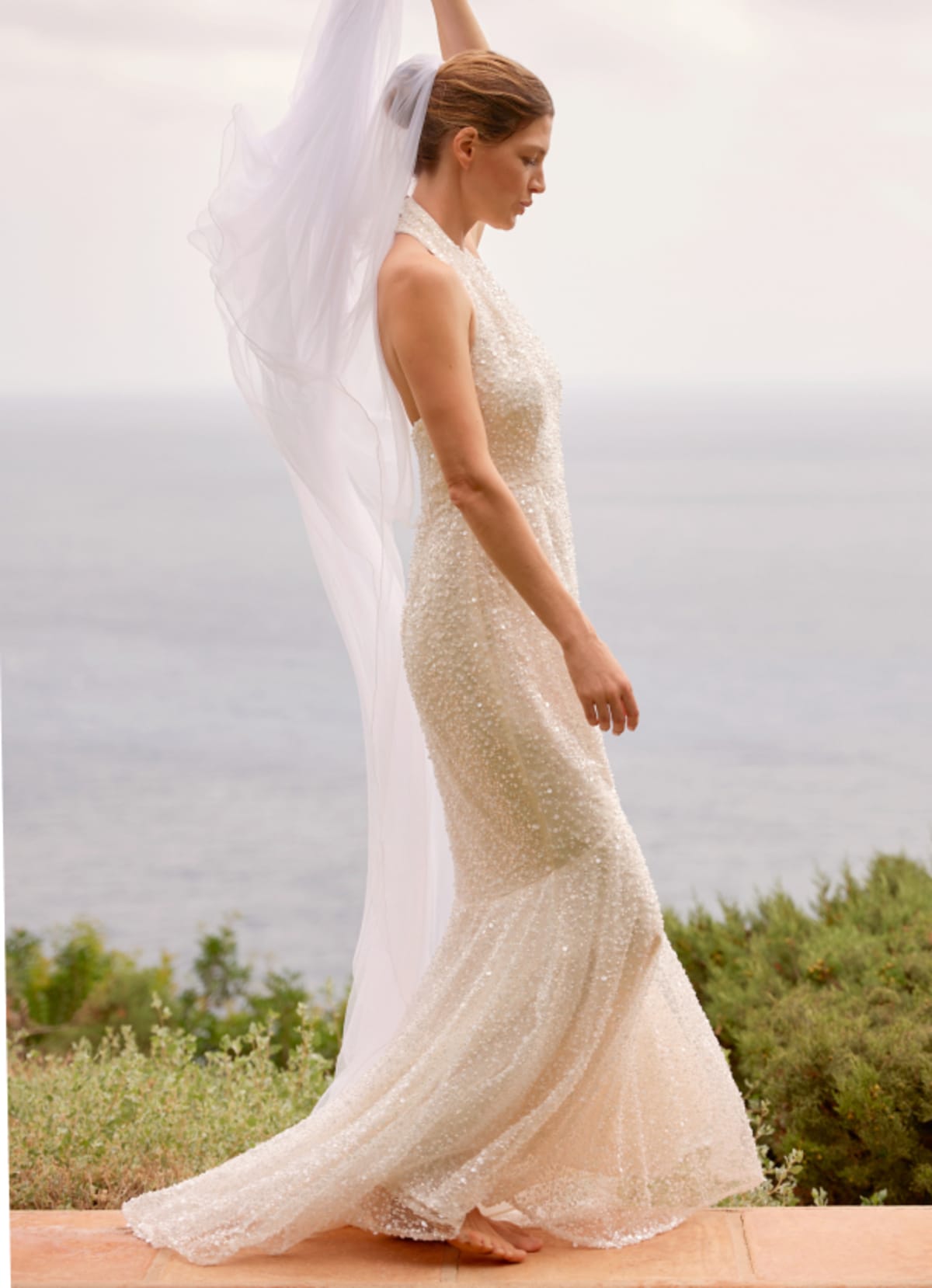 Woman wearing Phase Eight Guinevere Wedding Dress and holding Phase Eight Wedding Veil