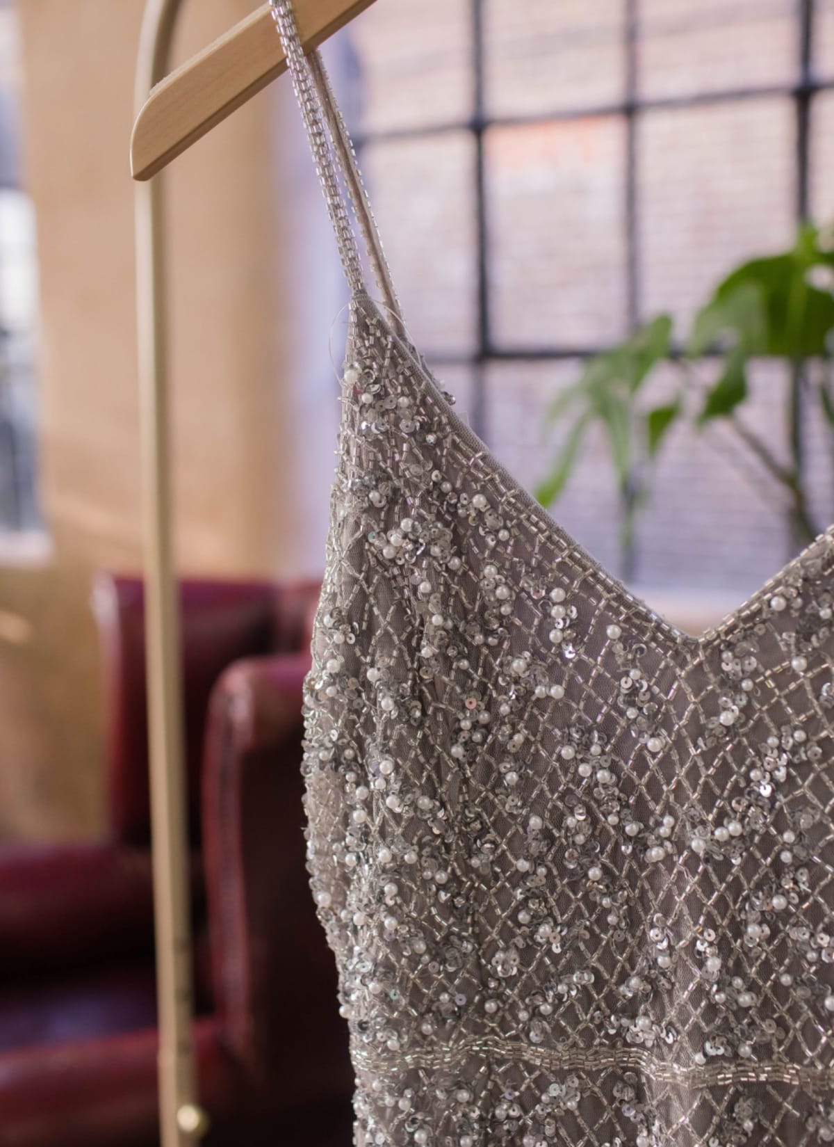 Close up of silver beaded dress on a hanger