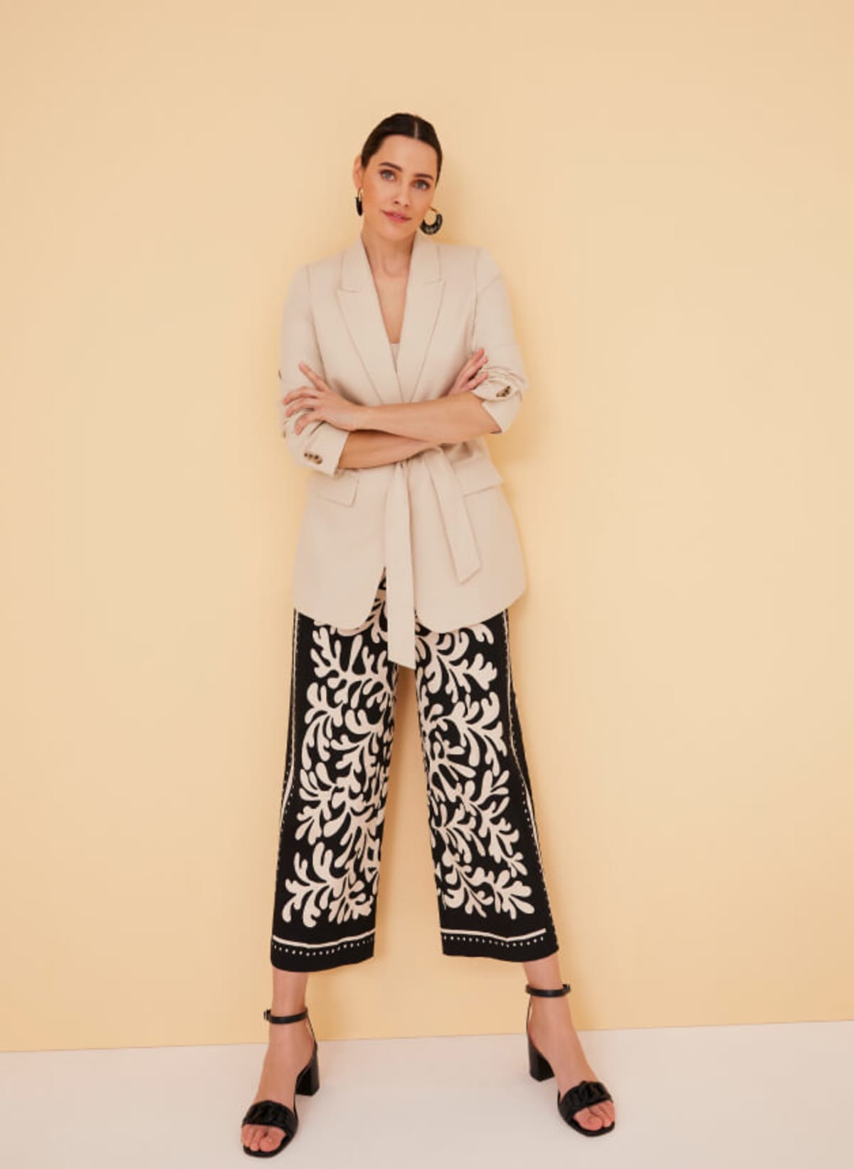 Woman wearing linen blazer and printed cropped trousers