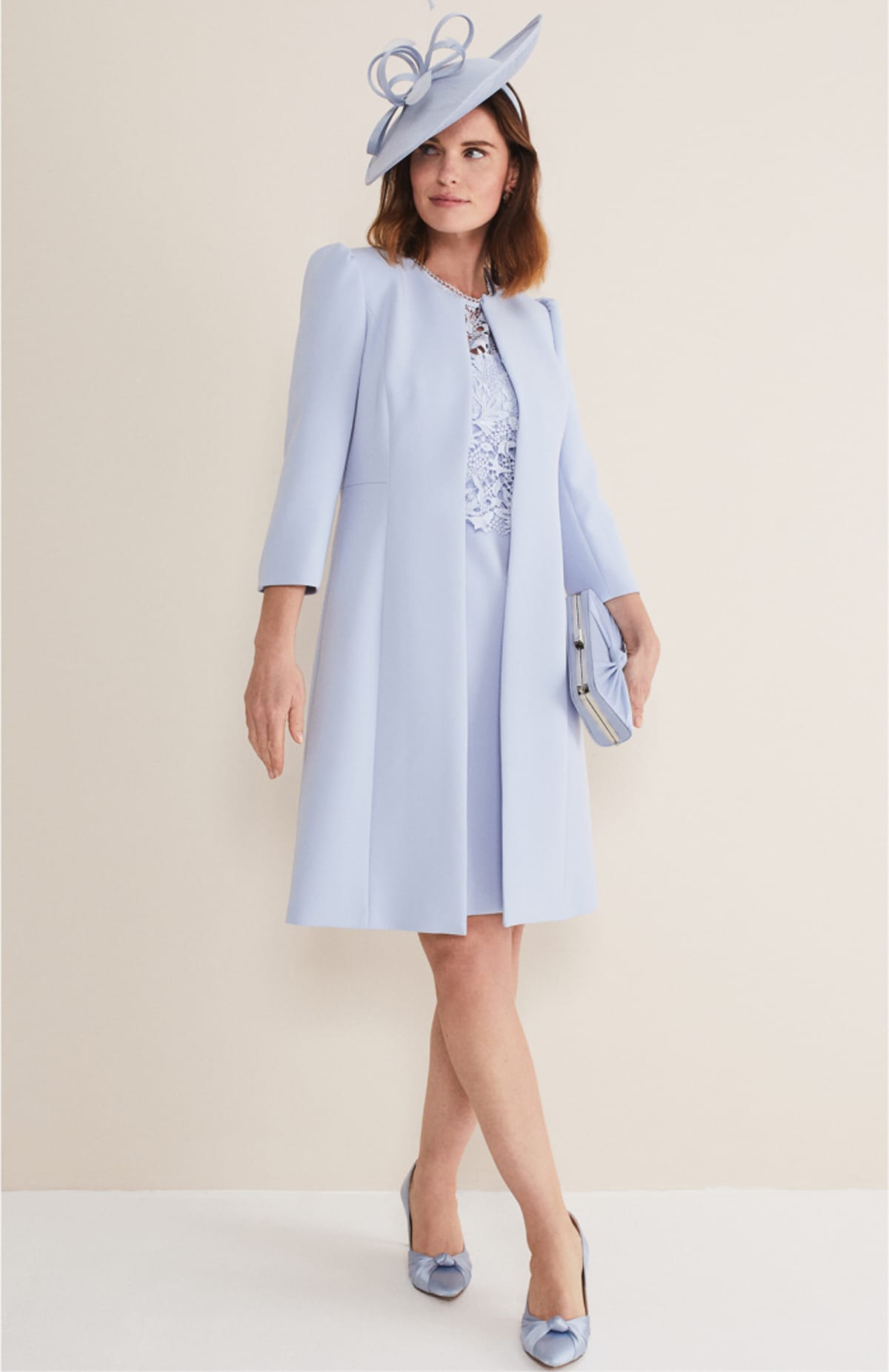 Woman wearing Phase Eight Venita Long Bow Jacket and matching blue accessories
