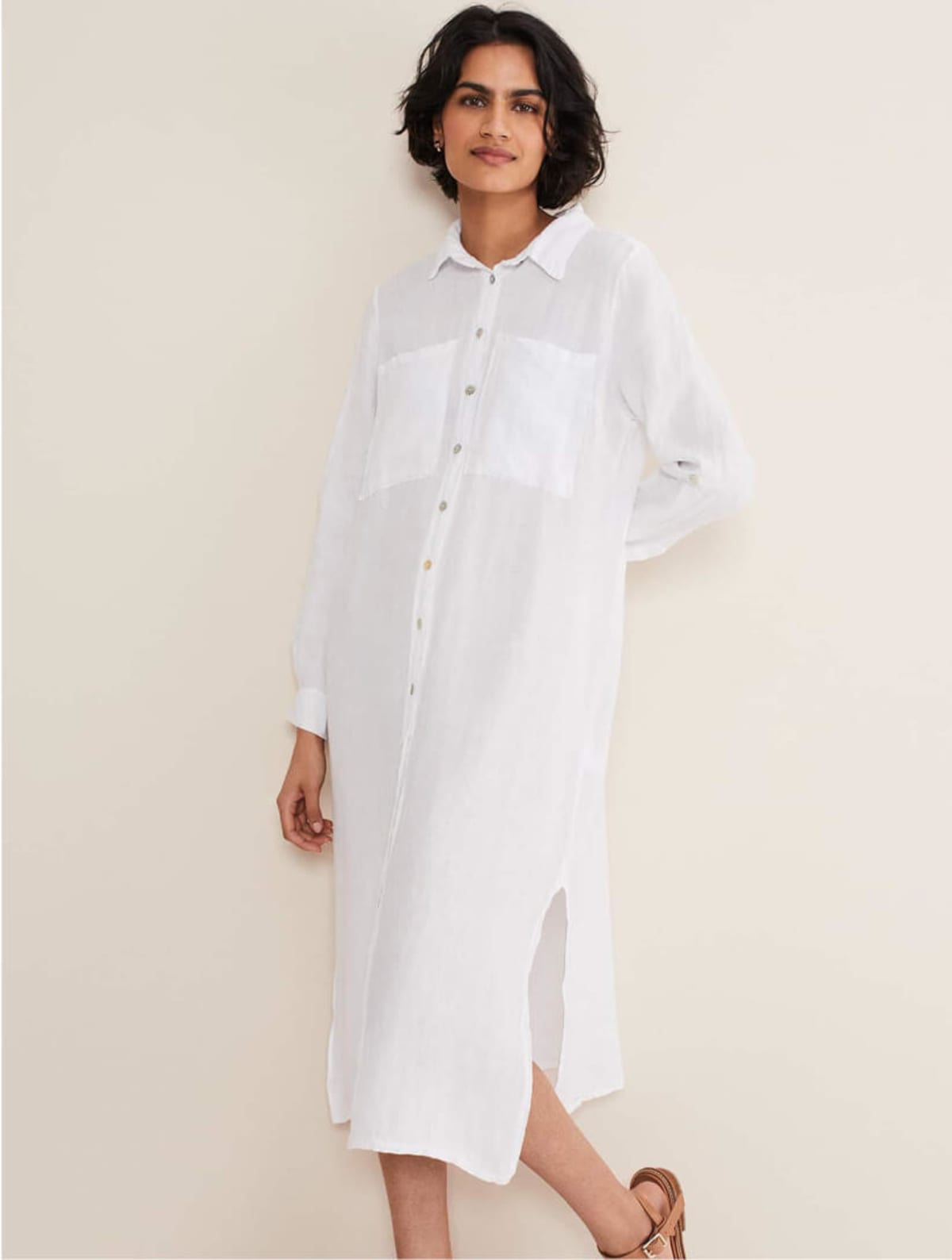 Woman wearing white linen shirt dress