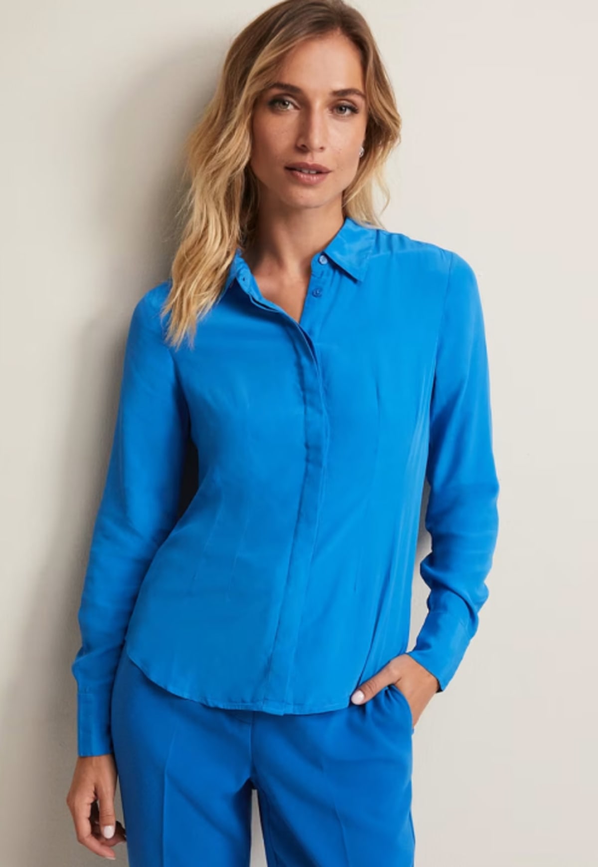 Woman wearing Phase Eight blue shirt