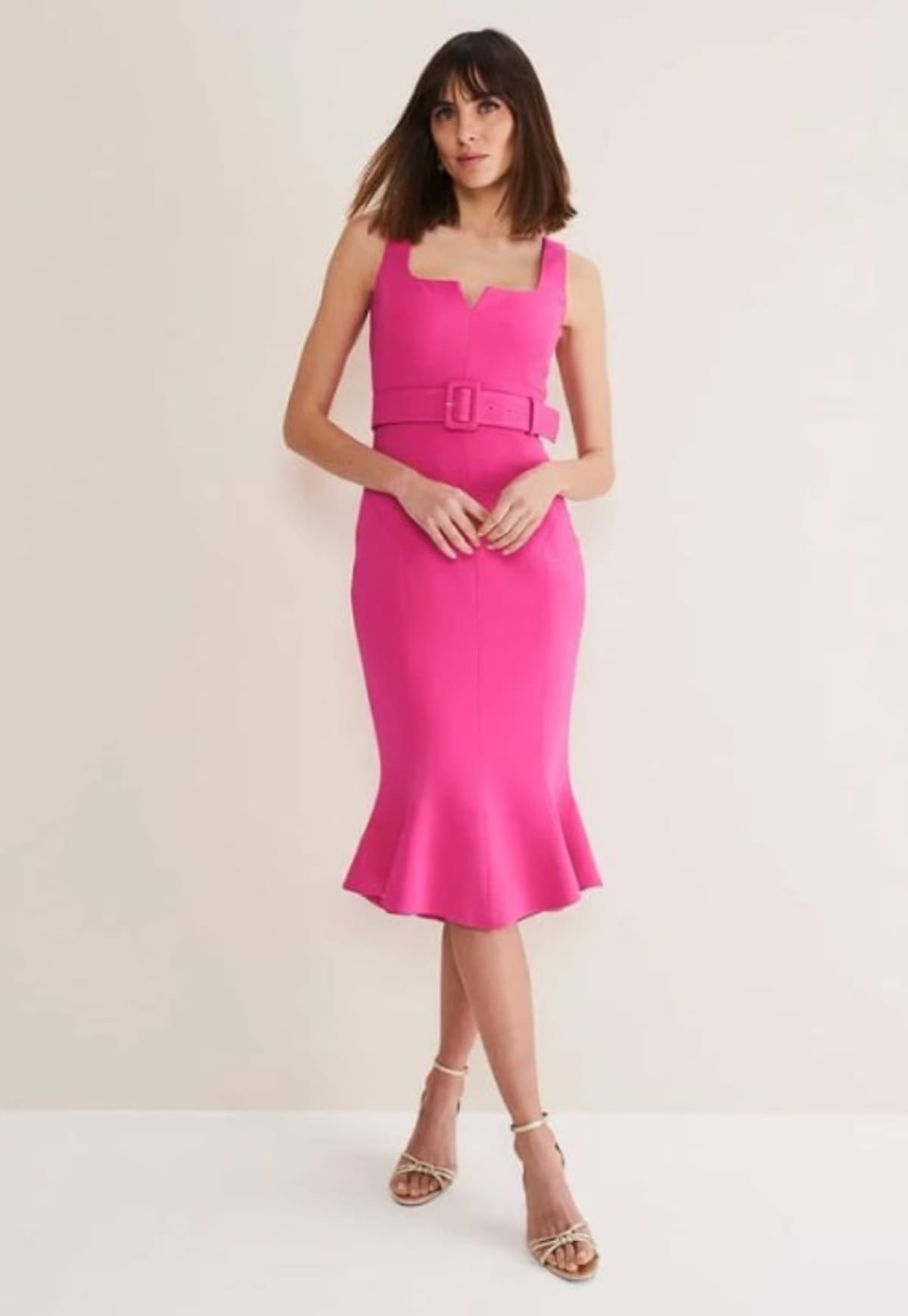 Woman wearing pink suit dress