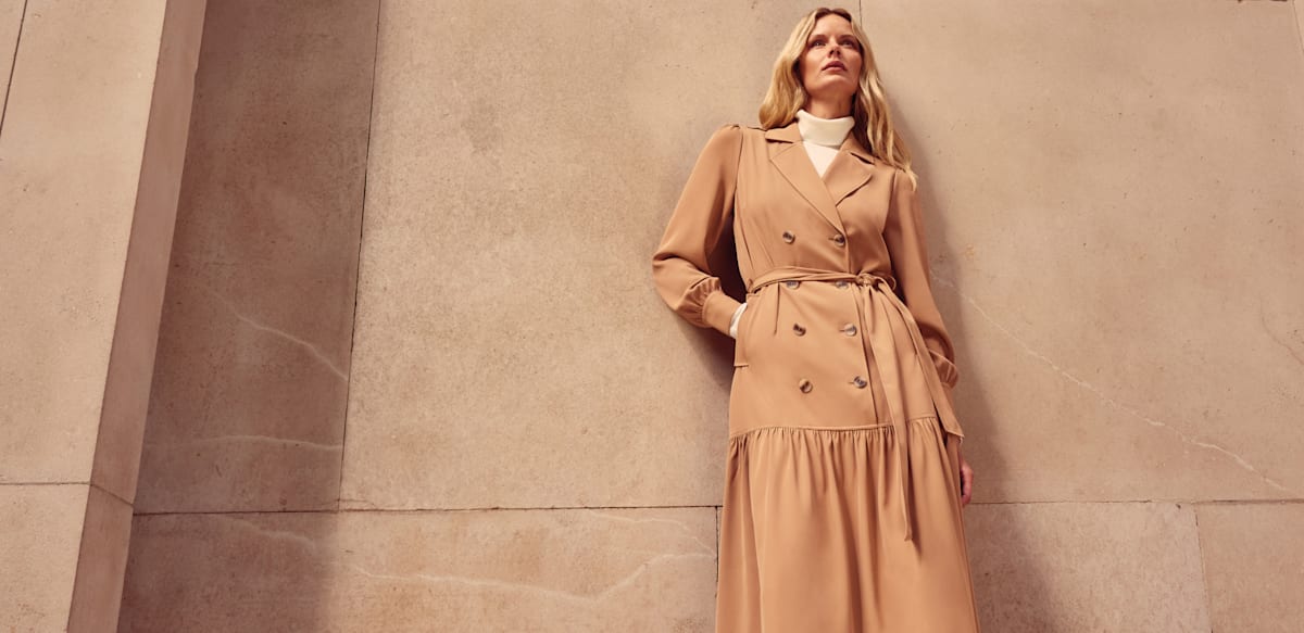Woman in Phase Eight beige trench dress
