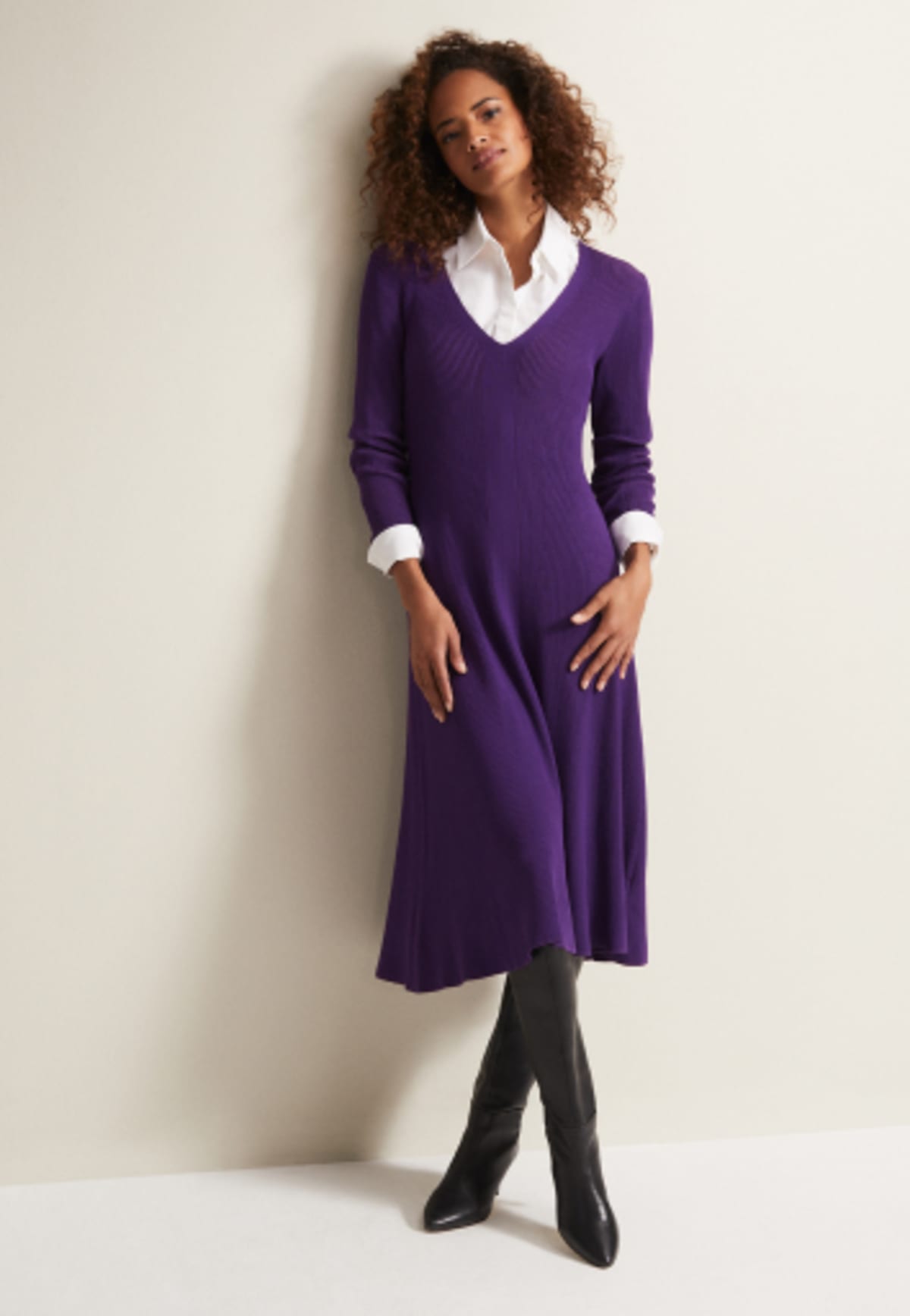 Woman in Phase Eight purple knitted dress over a white shirt