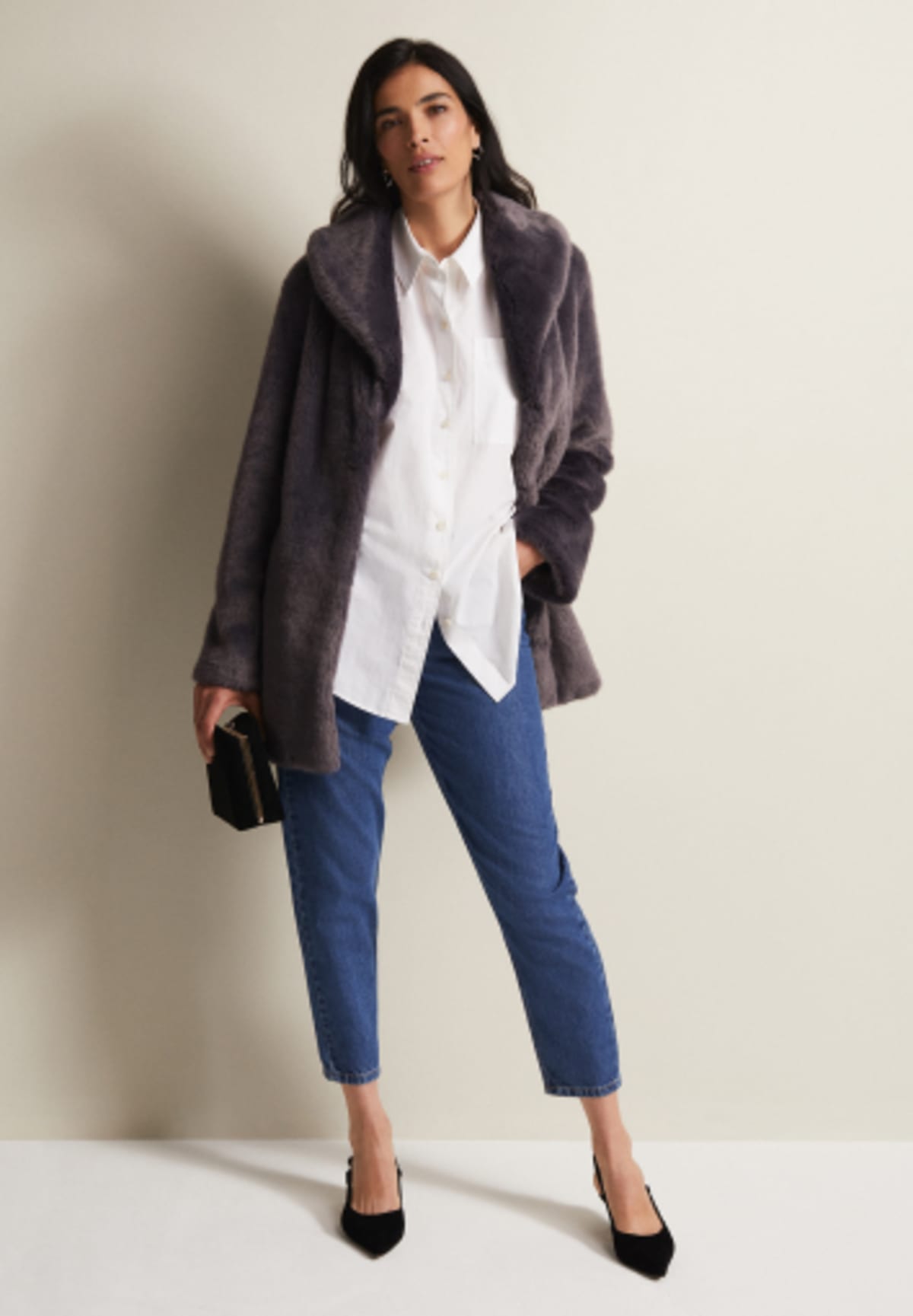 Woman in Phase Eight jeans, white shirt and faux fur coat