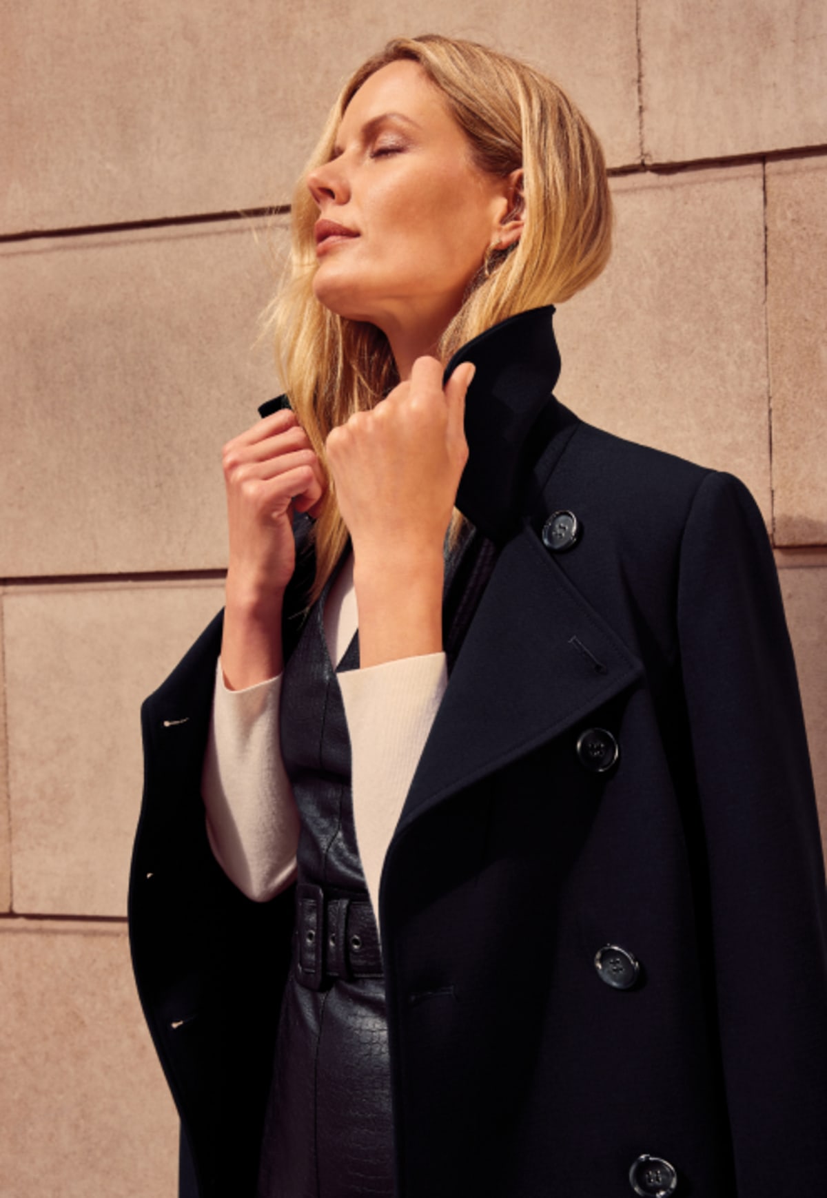 Woman in Phase Eight black coat