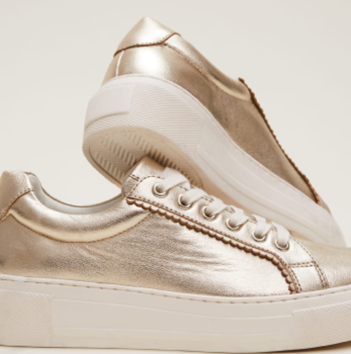 Gold leather trainers