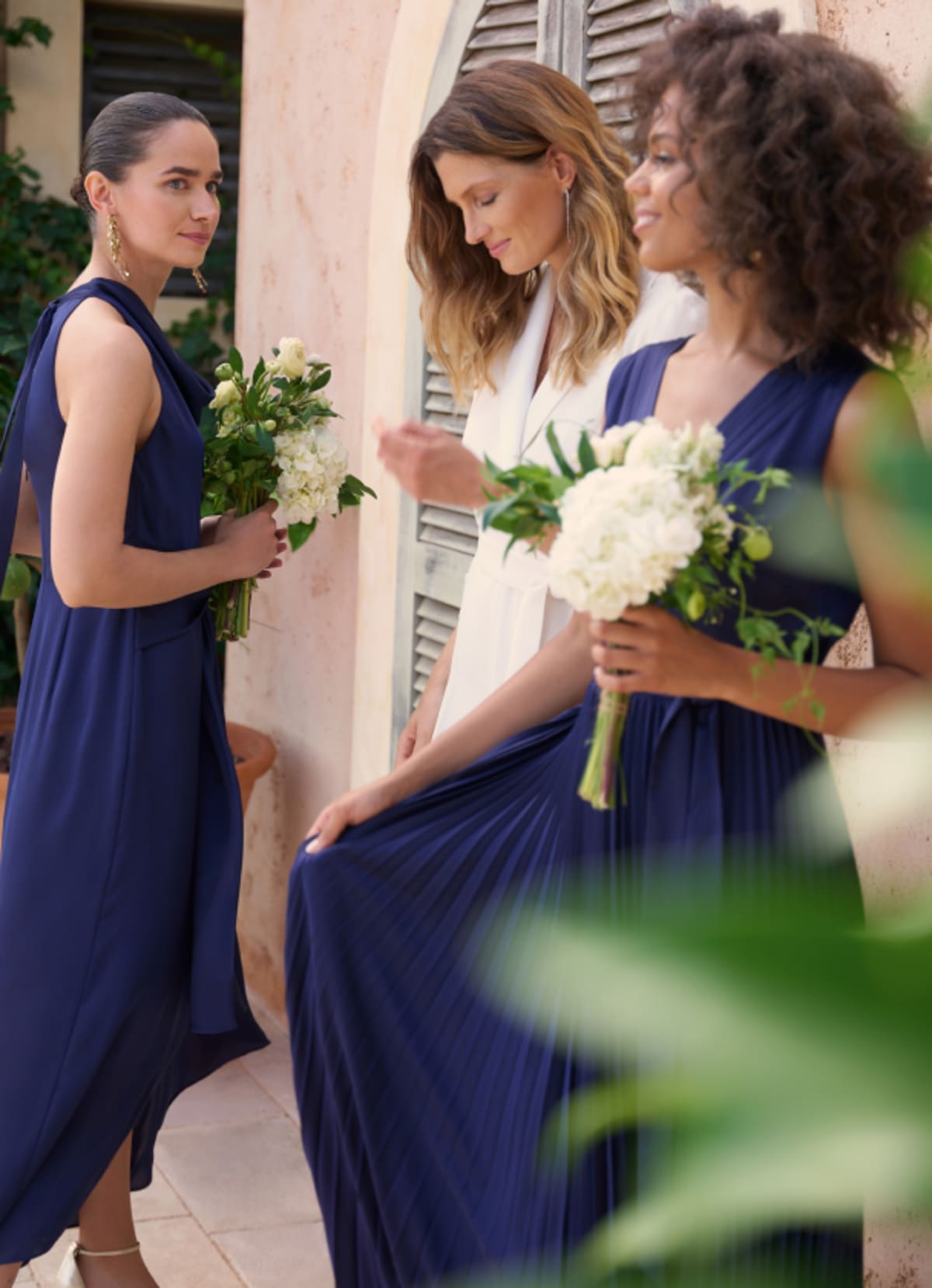 Woman wearing Phase Eight wedding dress with women wearing bridesmaid dresses