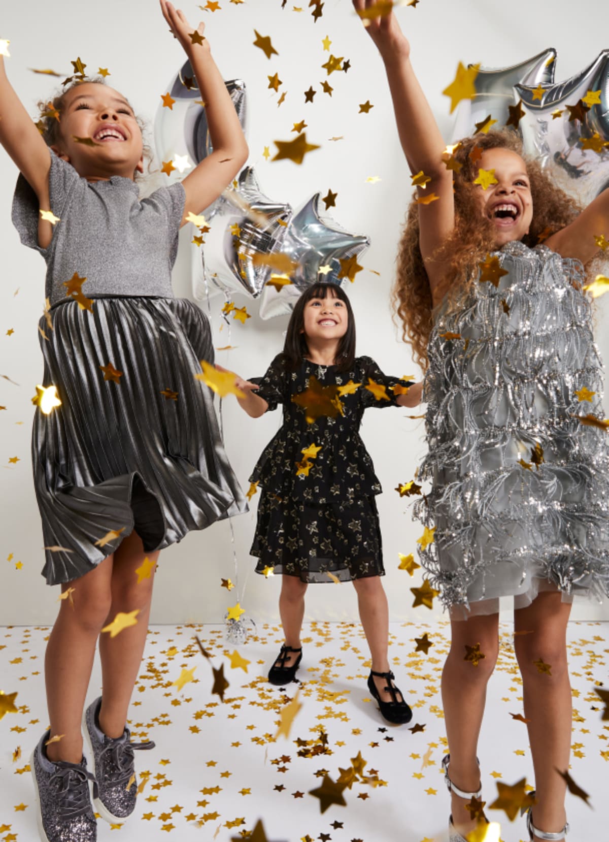 Girls playing in Phase Eight party dresses
