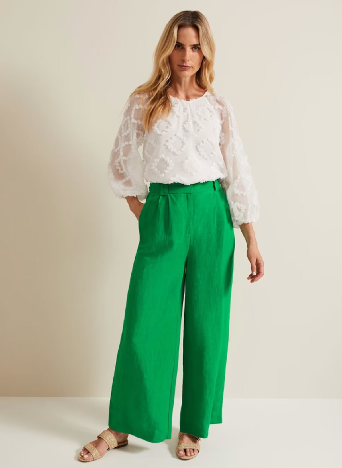 Woman wearing Phase Eight white blouse and green trousers