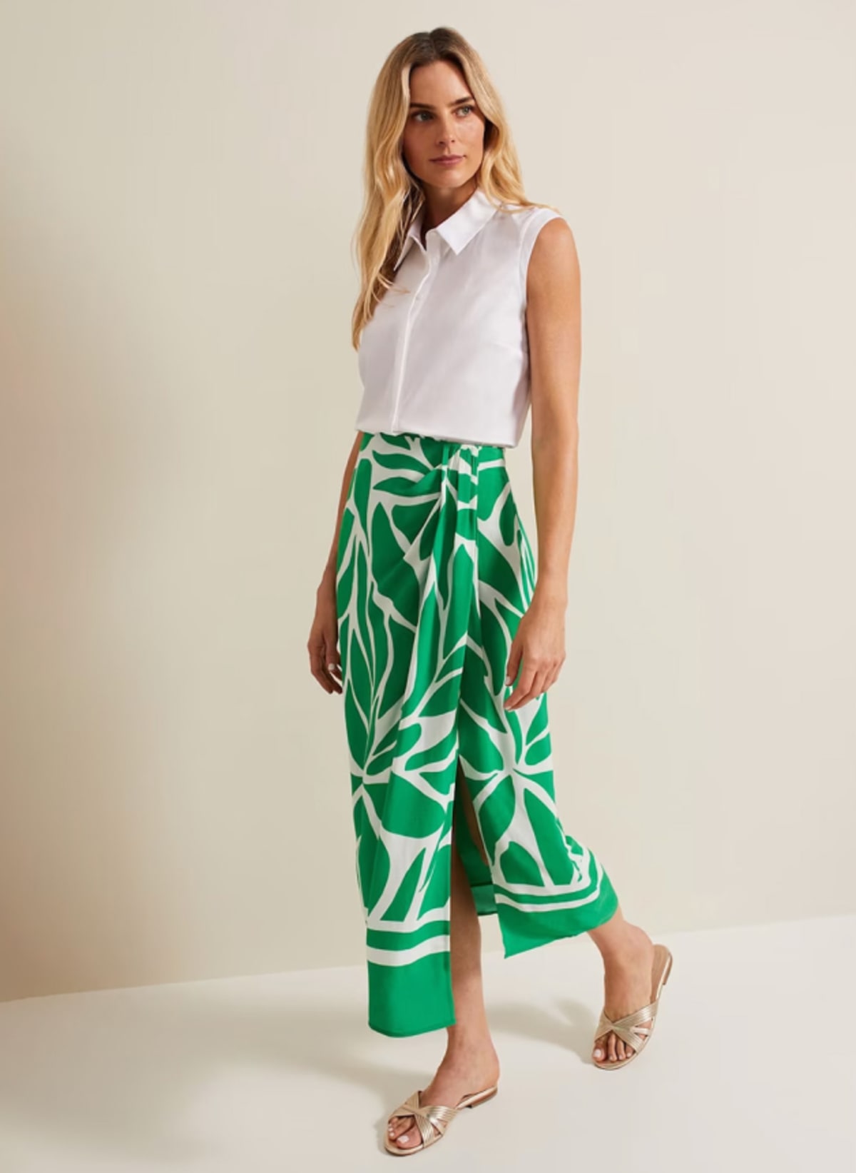Woman wearing Phase Eight printed green skirt and white top