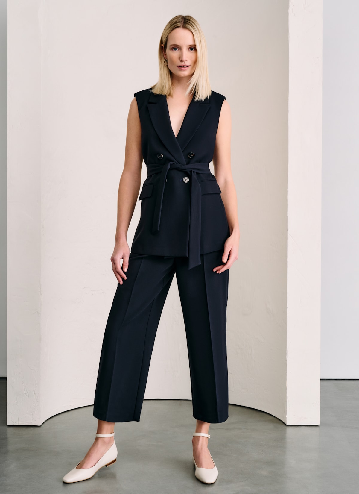Woman in Phase Eight tailored waistcoat and cropped trousers